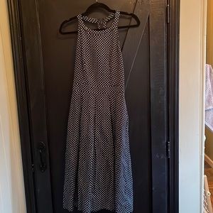 Navy and white polka dot dress. Back cut out. The limited size 2. Worn once.